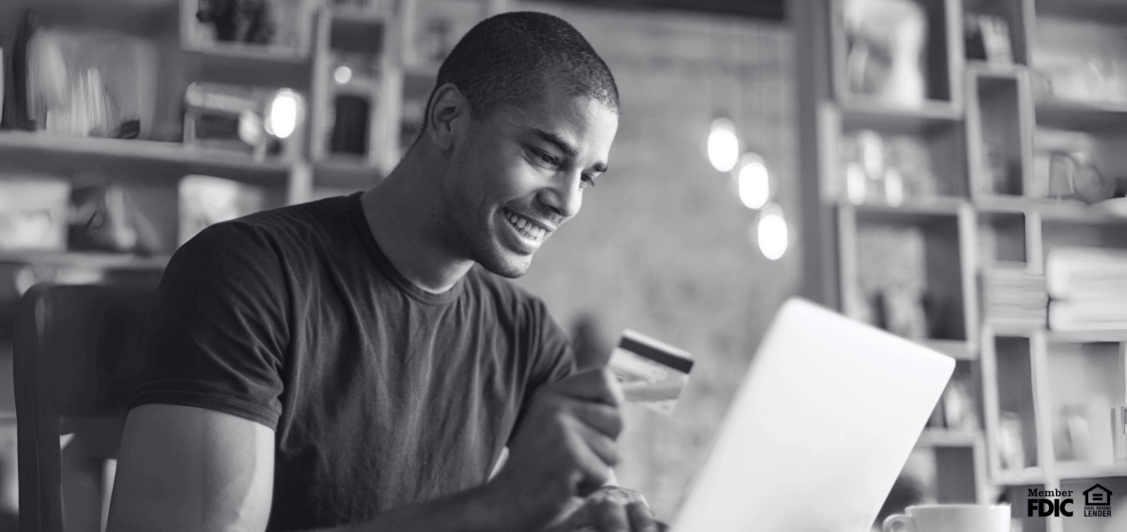 a young man checks the statement for his secured credit card.