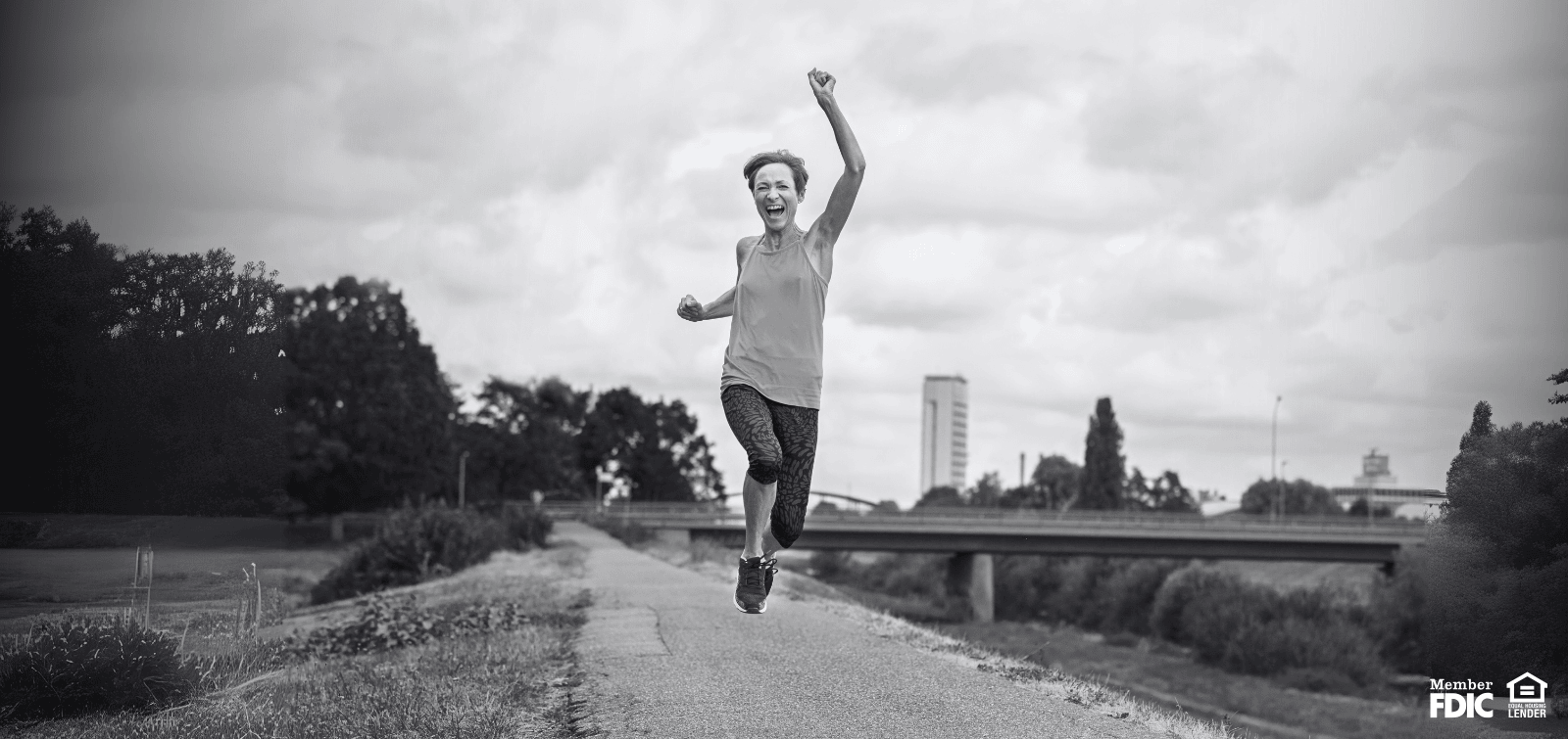 female jogger jumping for joy
