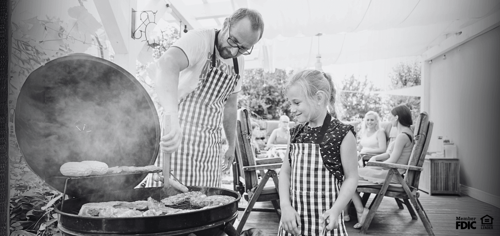 A father and daughter grill hamburgers on a patio paid for with a HELOC.