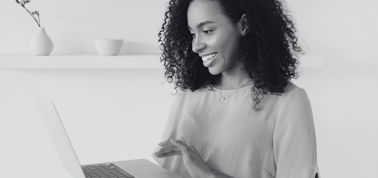 a woman researches checking accounts on her laptop