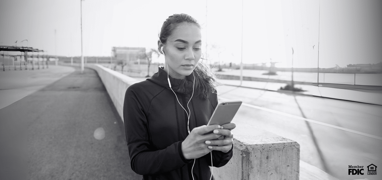 Woman reading texts and emails on her phone, staying safe from spoofing attacks.