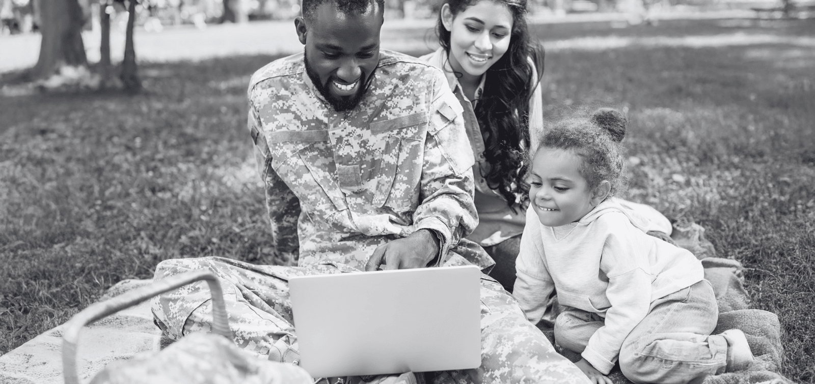 Military family sitting together while they view their automatic savings.