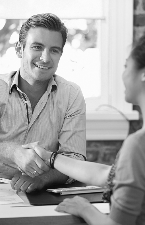 a man smiles while completing a business deal