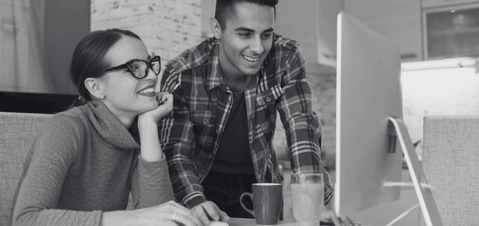 a man and woman check the status of their personal military loan online