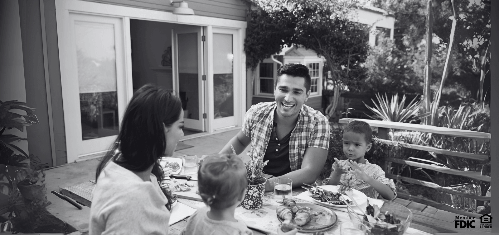 a family enjoys dinner on the deck they were able to build with funds from a HELOC