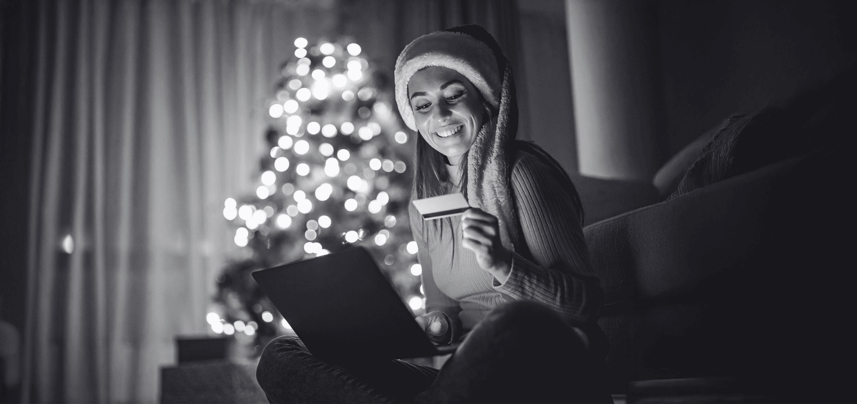 Woman maximizing cash back, bonuses, and discounts while holiday shopping with the best rewards checking account.