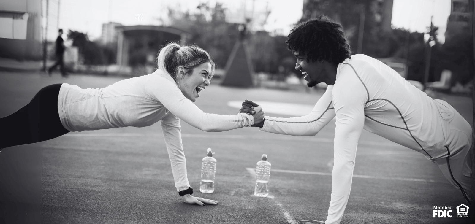 two friends working out together, happy they are both saving with money markets.