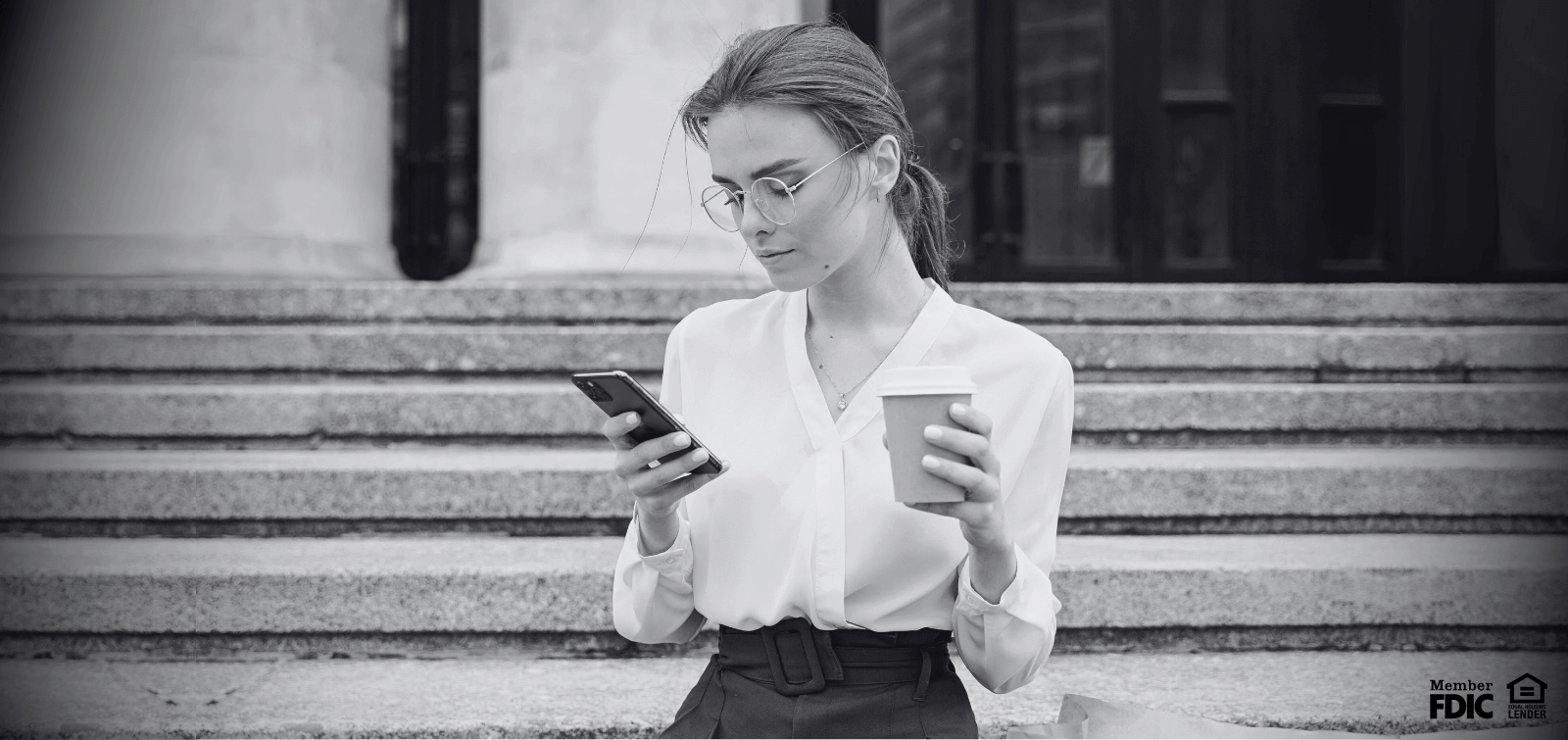 Woman looking at her mobile phone to make sure she doesn't fall victim to a SIM swapping scam.