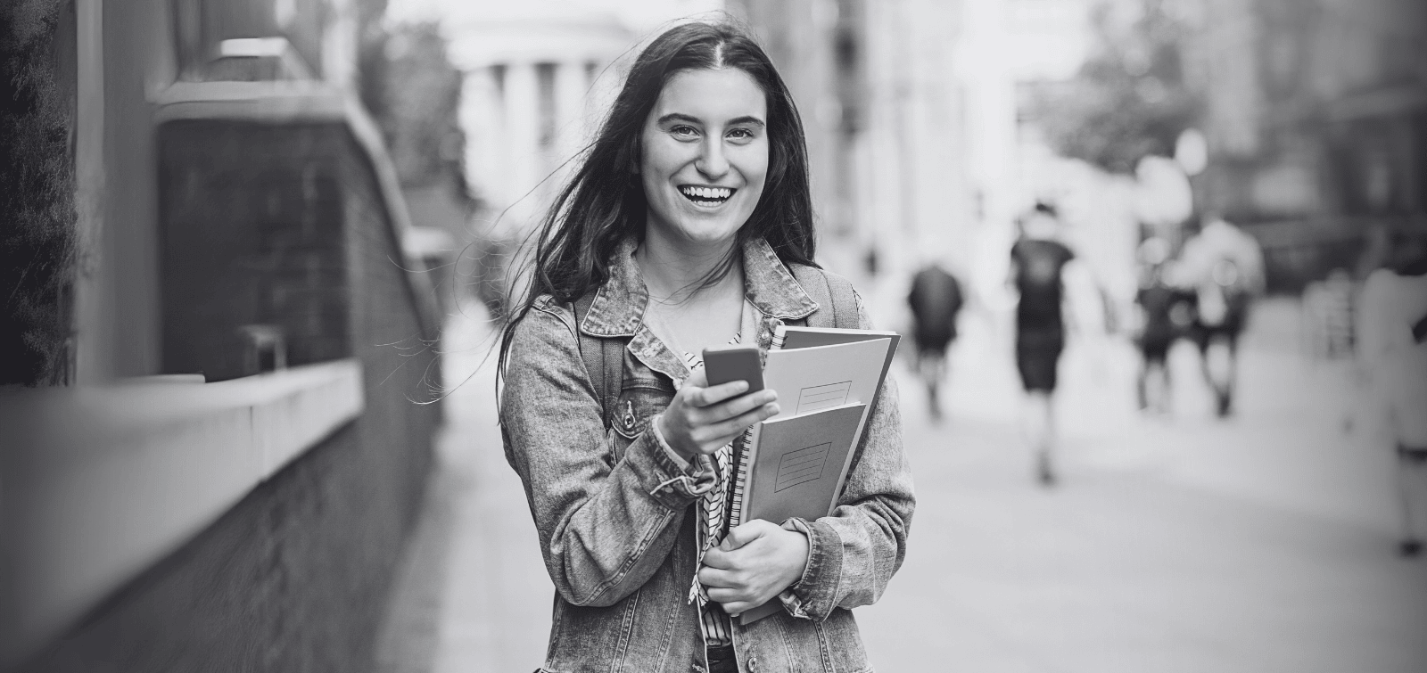 Young adult / university student who is happy to build credit with the best credit card for college students.