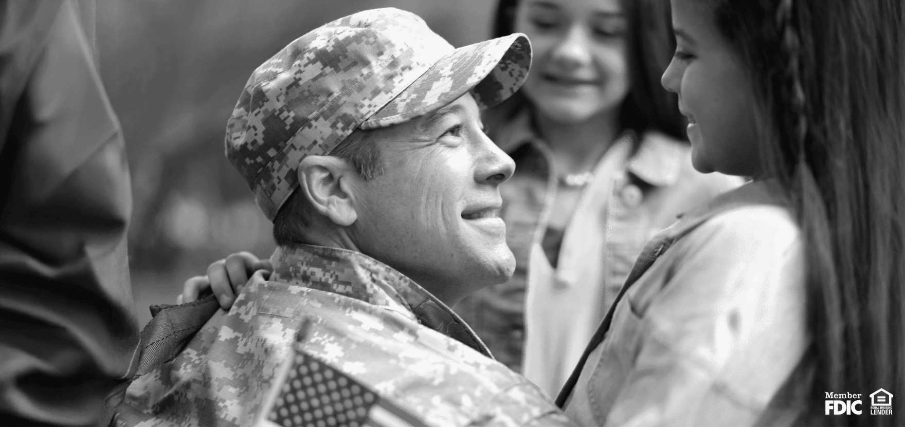 Active-duty military service member with his daughter, feeling financially secure with a military bank.