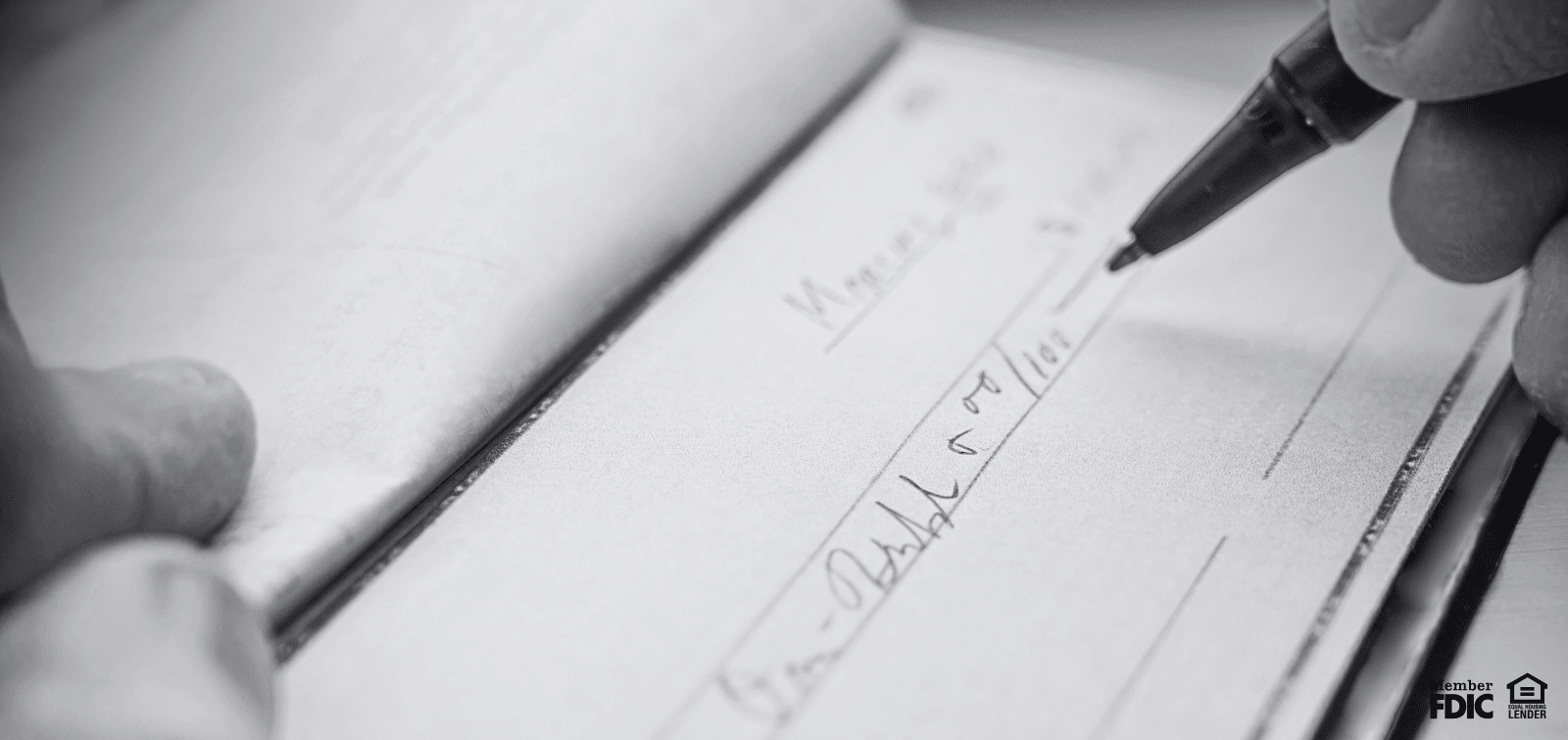 Person writing a check from their money market account.