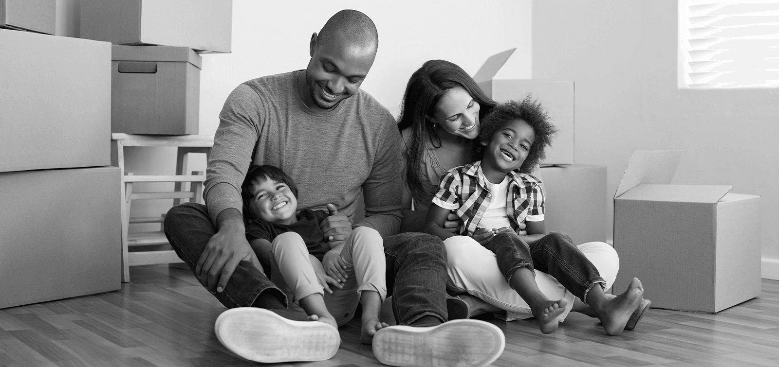 military family sit in a room filled with boxes while preparing for a PCS move.