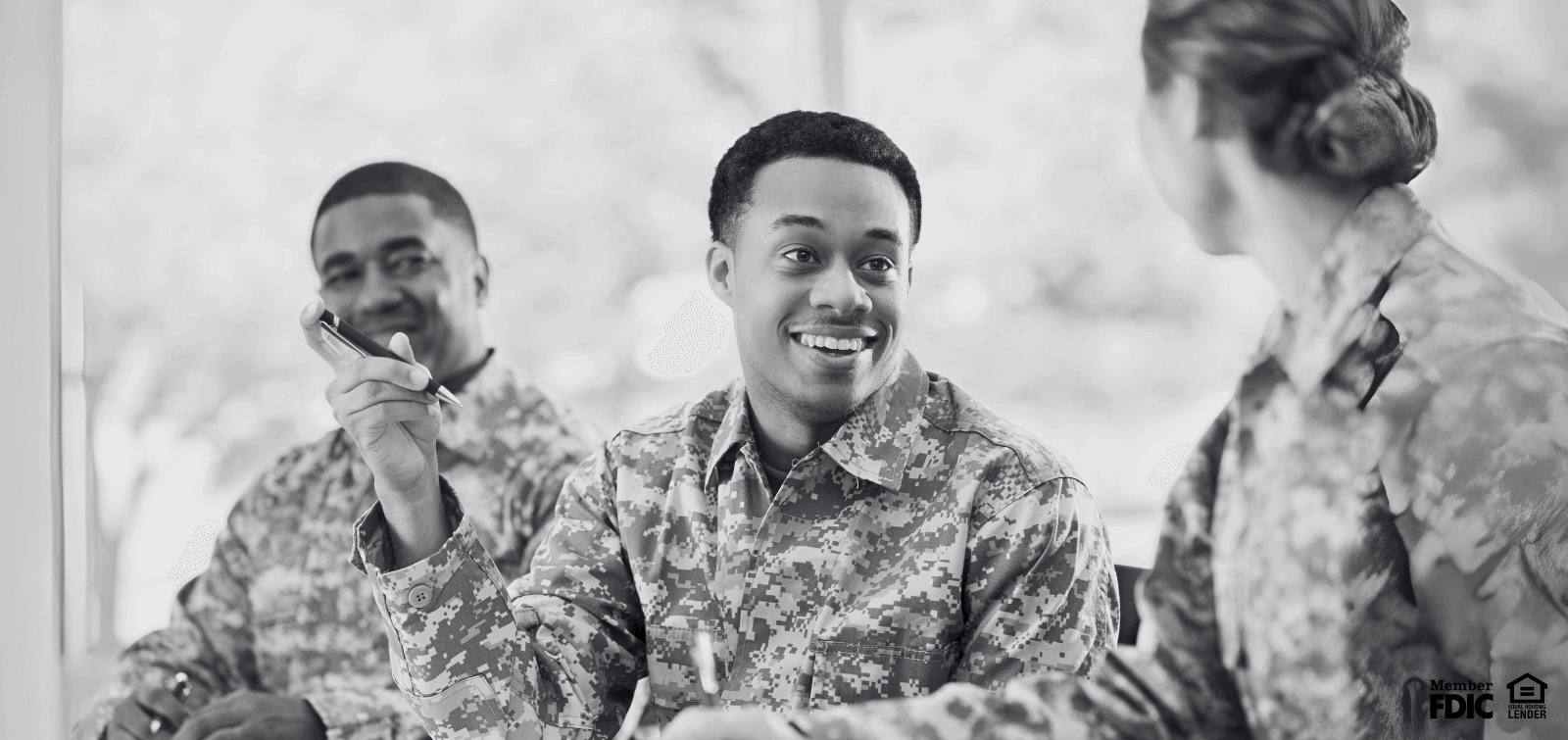 three soldiers chat and laugh together,  happy to get paid early with early pay