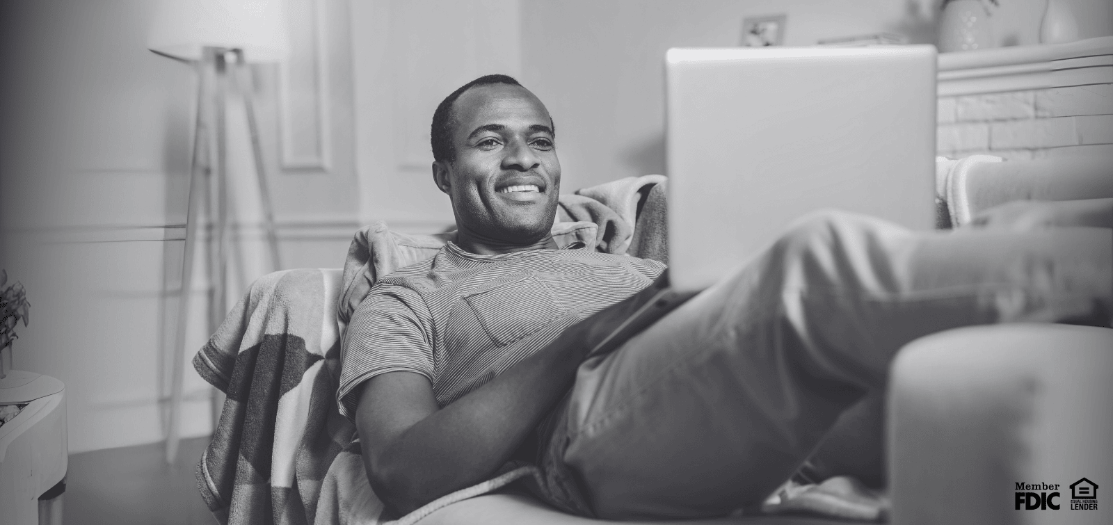 Bank using his laptop to view his interest-bearing checking account.